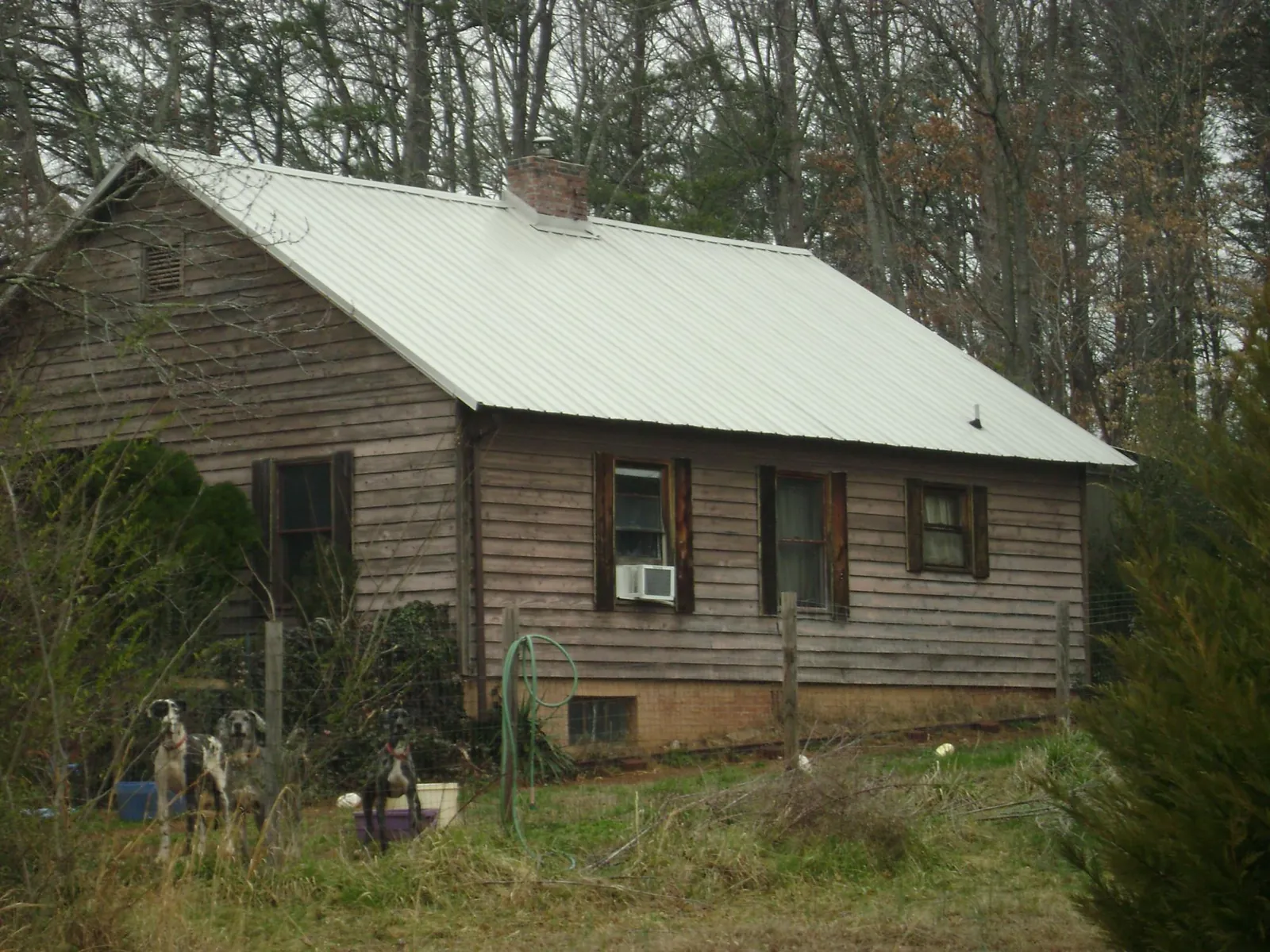 White metal roof on an old wood sided farmhouse, from a Metal Roof Installation job in Glenfield